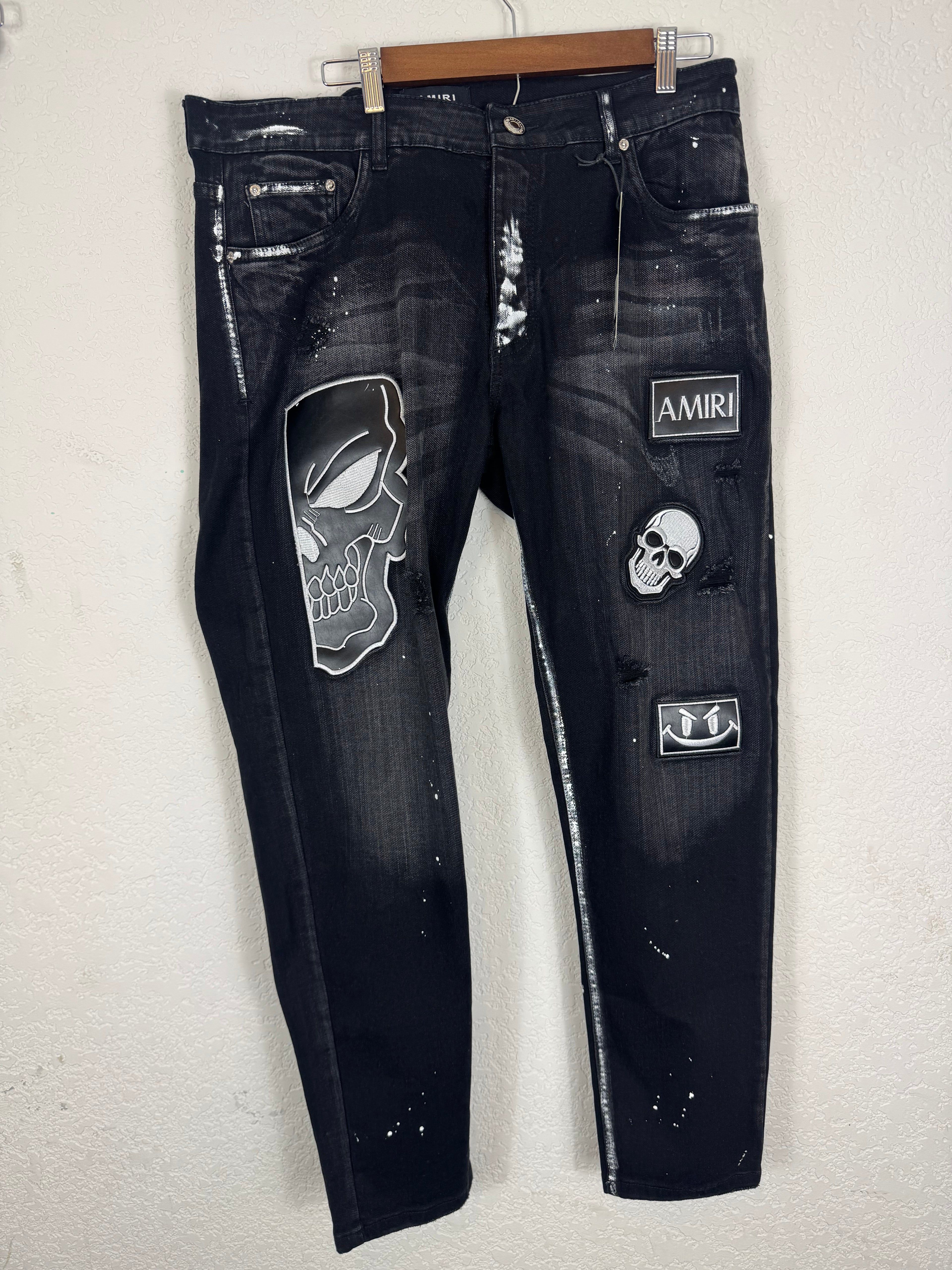 Amiri distressed black patch jeans