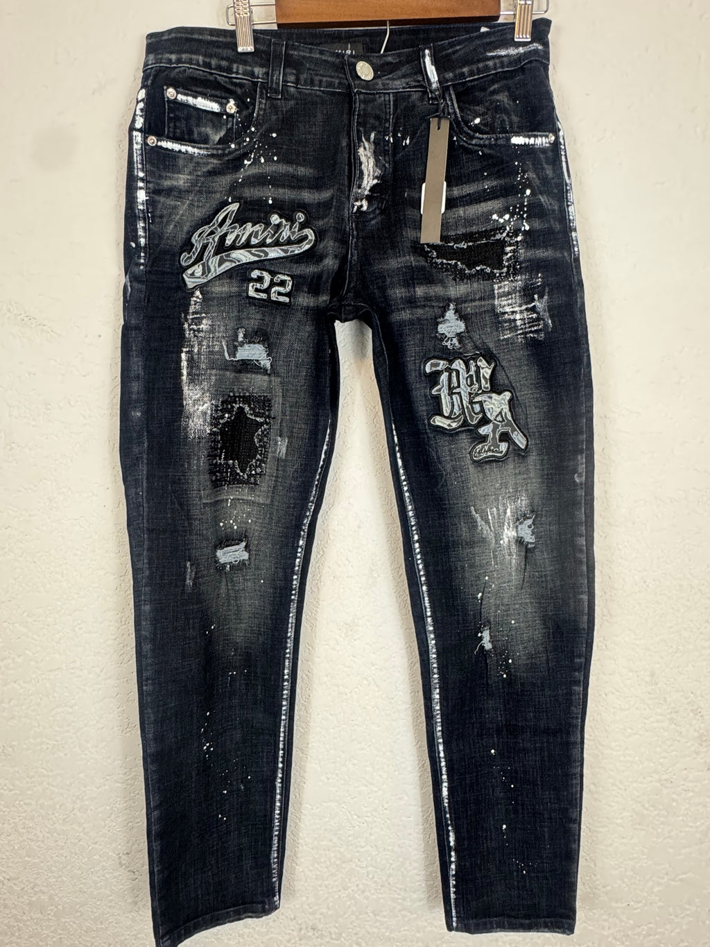AMIRI distressed varsity patch jeans