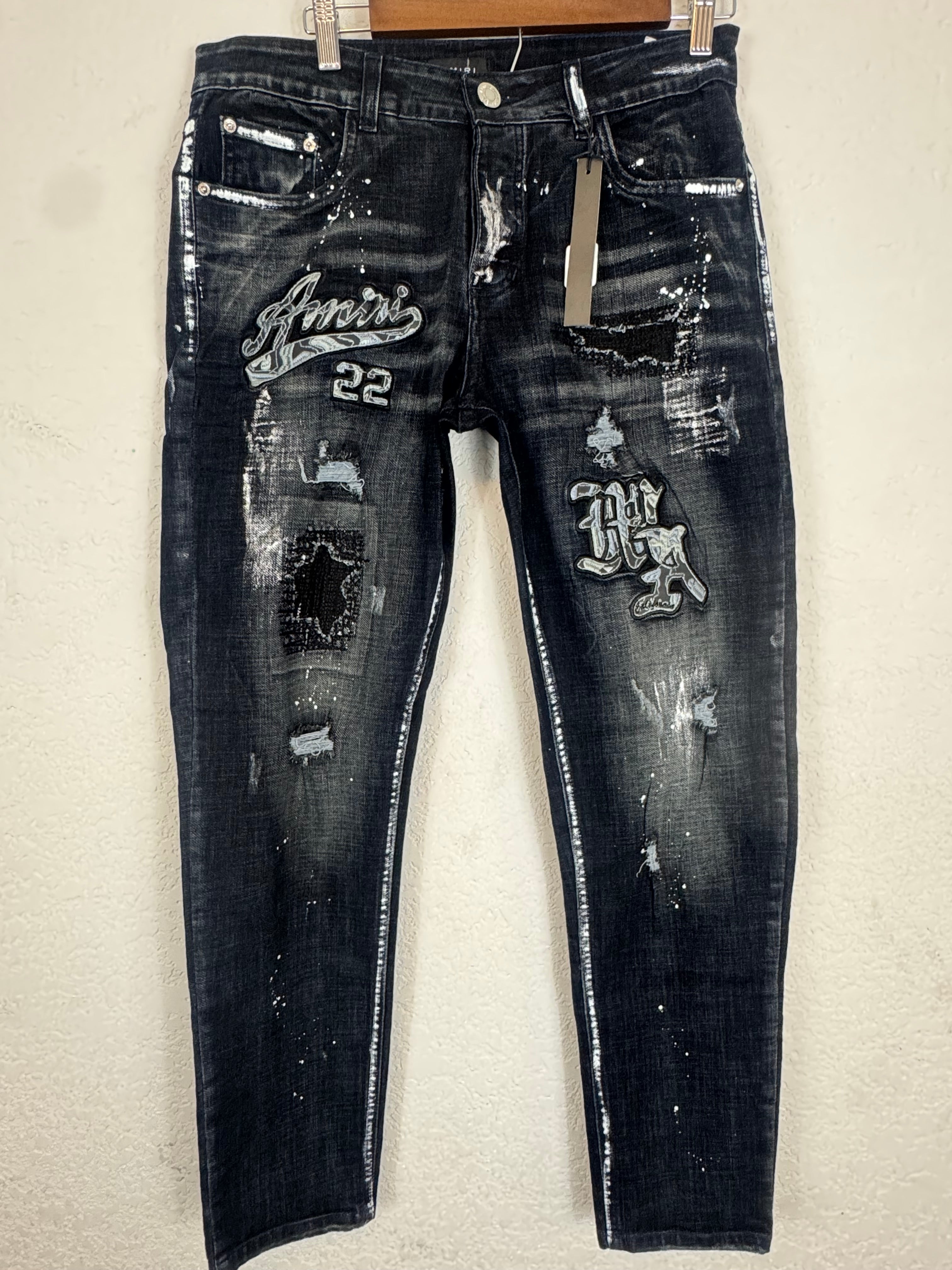 AMIRI distressed varsity patch jeans