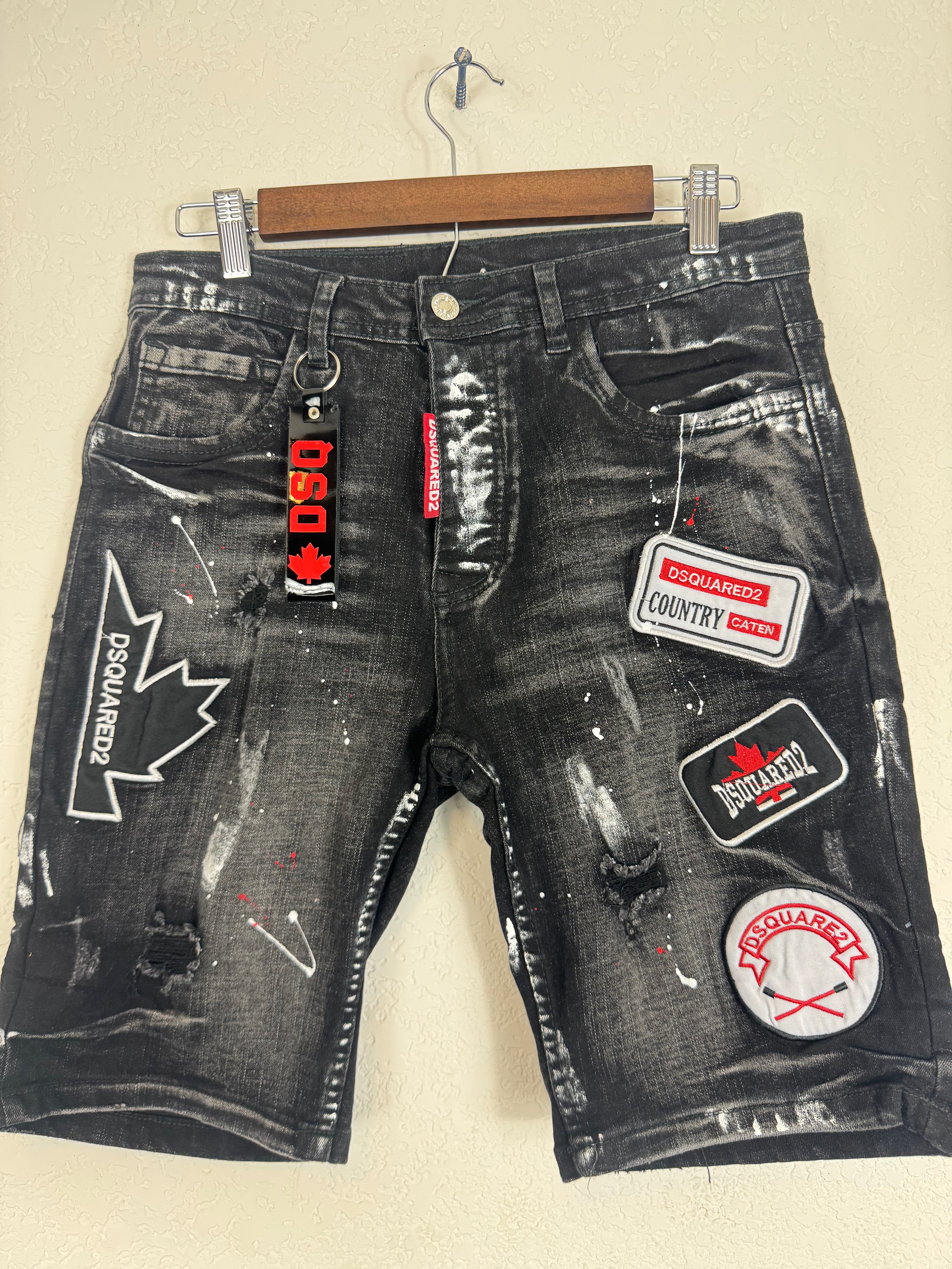 Dsquared2 men's denim shorts feature extensive distressing,