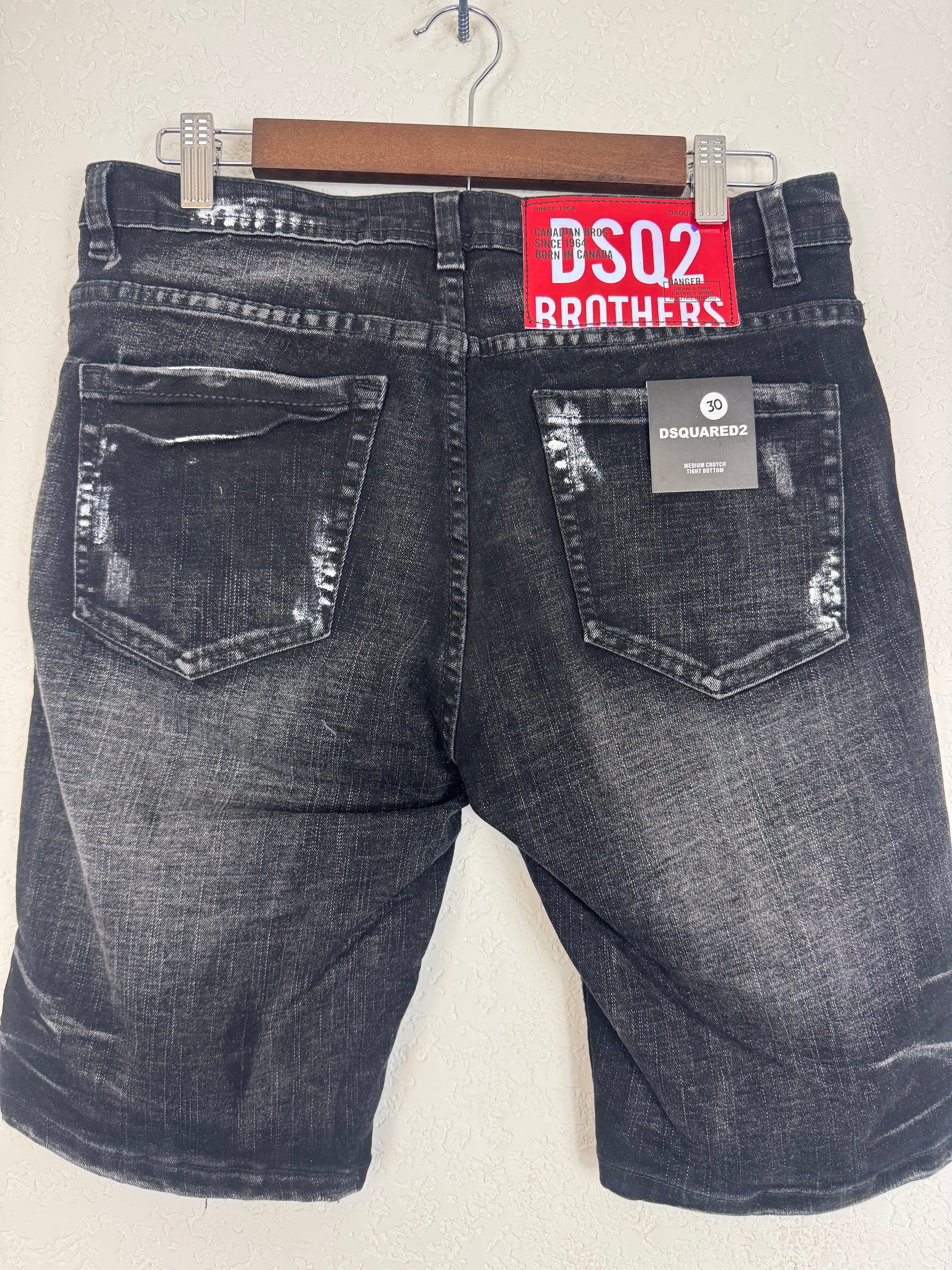 Dsquared2 men's denim shorts feature extensive distressing,