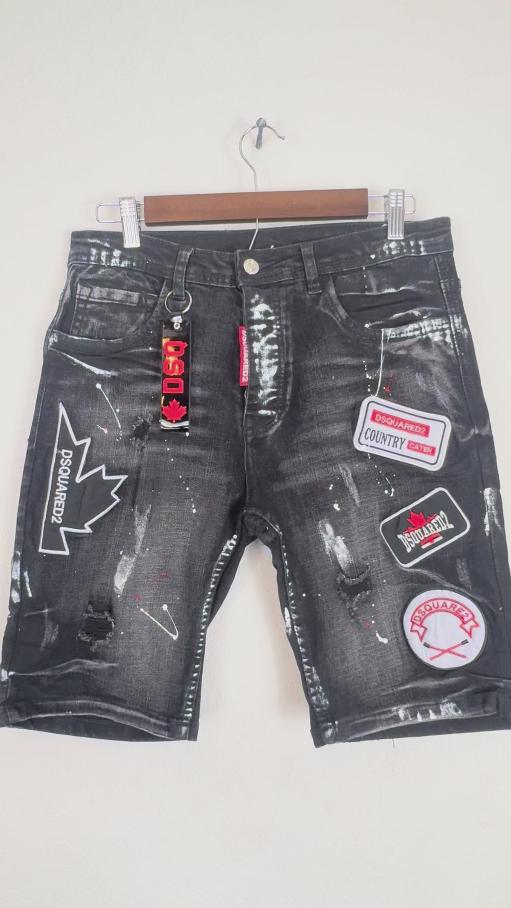 Dsquared2 men's denim shorts feature extensive distressing,