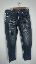 AMIRI distressed varsity patch jeans